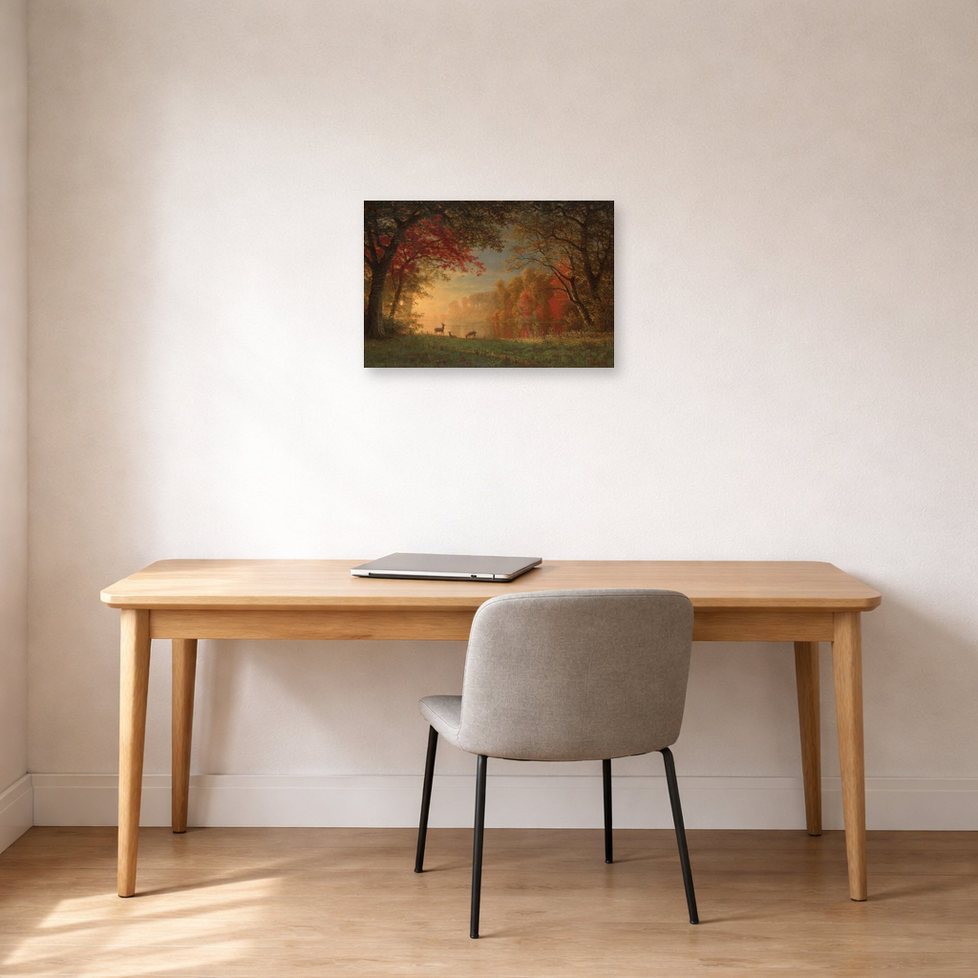 Unframed poster print of Albert Bierstadt's 'Indian Sunset: Deer by a Lake' displayed on a wall in a office