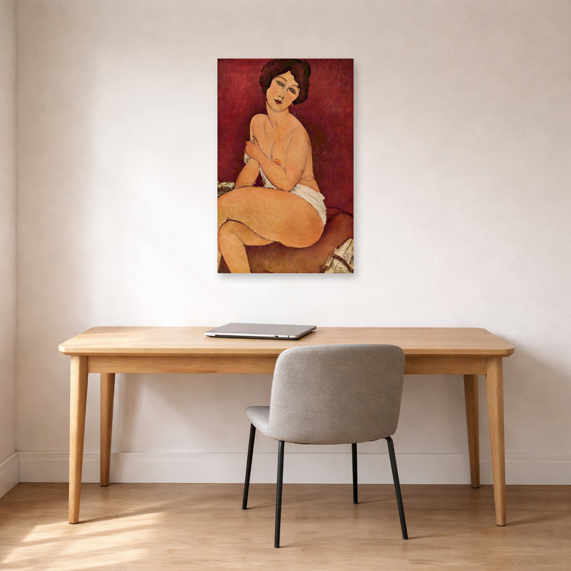 Unframed poster print of Amedeo Modigliani's Nude Sitting on a Divan (La Belle Romaine) displayed on a wall in an office