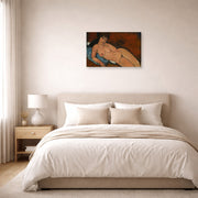 Gallery-wrapped canvas print of Amedeo Modigliani's Nude on a Blue Cushion displayed on a wall in a bedroom