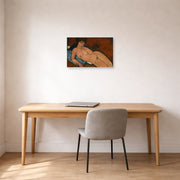 Unframed poster print of Amedeo Modigliani's Nude on a Blue Cushion displayed on a wall in an office