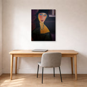 Gallery-wrapped canvas print of Amedeo Modigliani's Portrait of Jeanne Hebuterne displayed on a wall in an office
