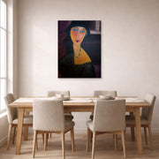 Unframed poster print of Amedeo Modigliani's Portrait of Jeanne Hebuterne displayed on a wall in a dining room