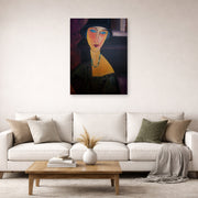 Unframed poster print of Amedeo Modigliani's Portrait of Jeanne Hebuterne displayed on a wall in a second living room setting