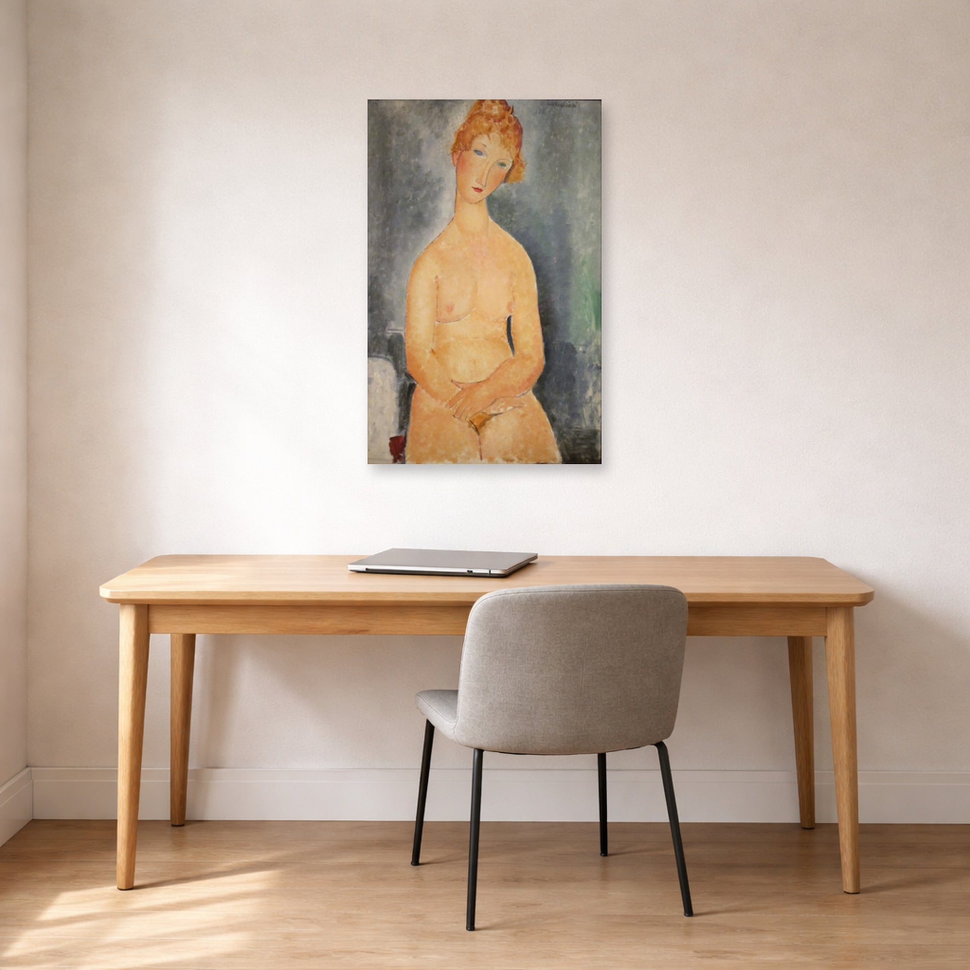 Unframed poster print of Amedeo Modigliani's Seated Nude displayed on a wall in an office