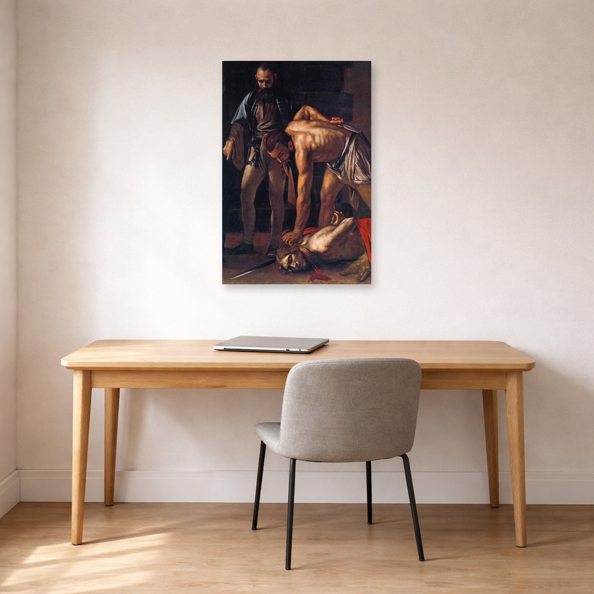Unframed poster print of Caravaggio's 'Beheading of Saint John the Baptist' displayed on a wall in an office