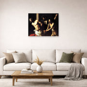 Unframed poster print of Caravaggio's 'Christ of the Column' displayed on a wall in a living room