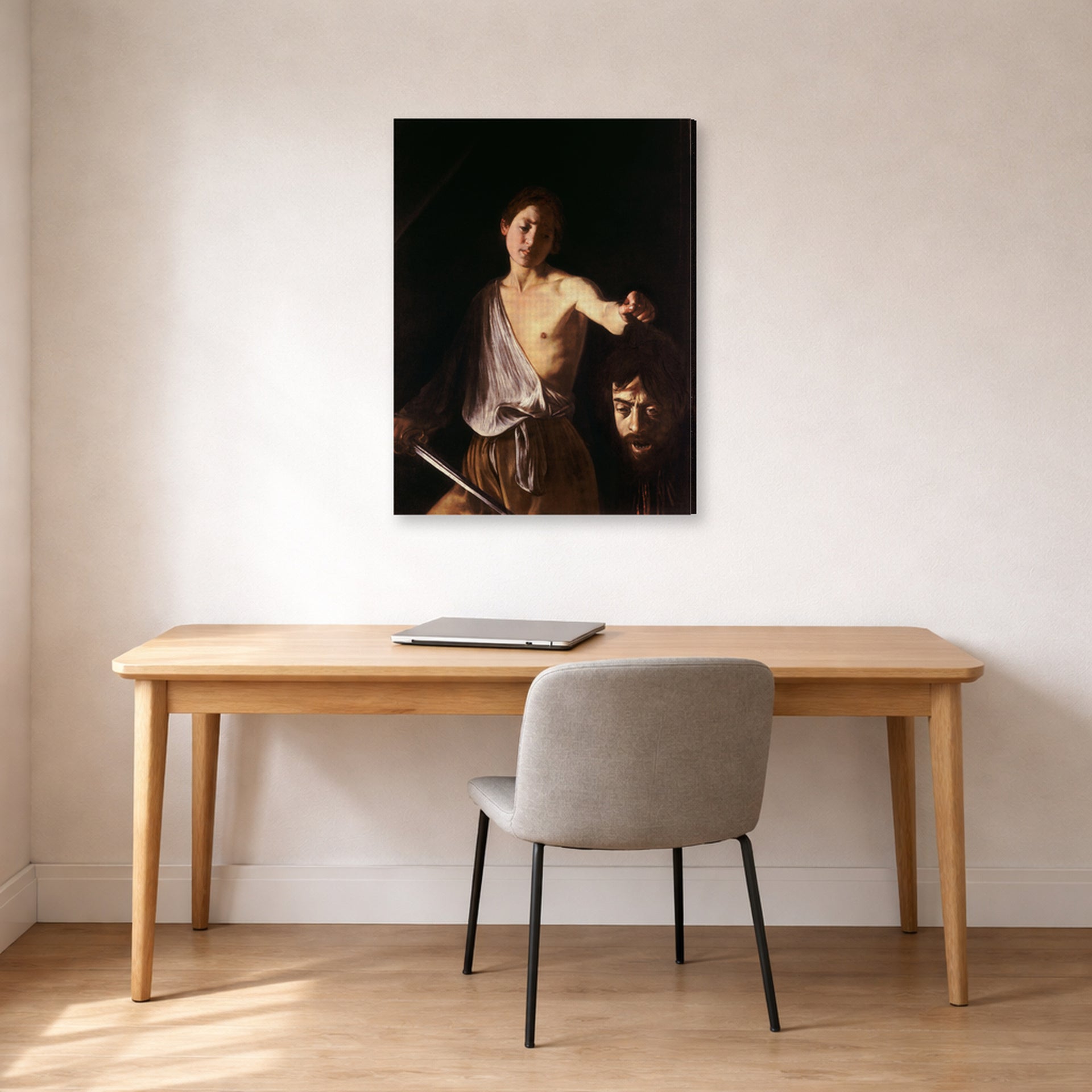 Gallery-wrapped canvas print of Caravaggio's 'David with the Head of Goliath' displayed on a wall in an office
