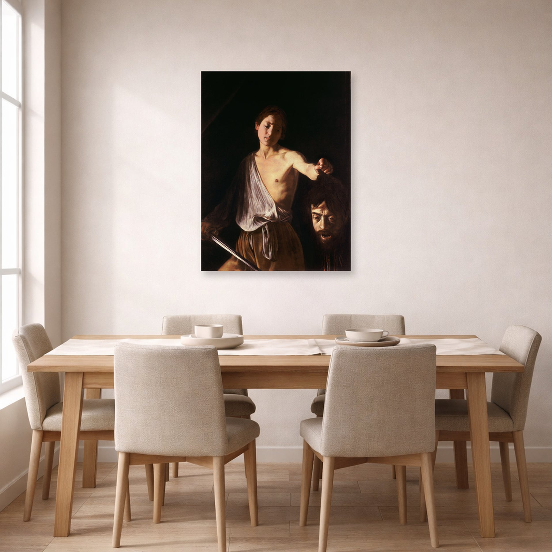 Unframed poster print of Caravaggio's 'David with the Head of Goliath' displayed on a wall in a dining room