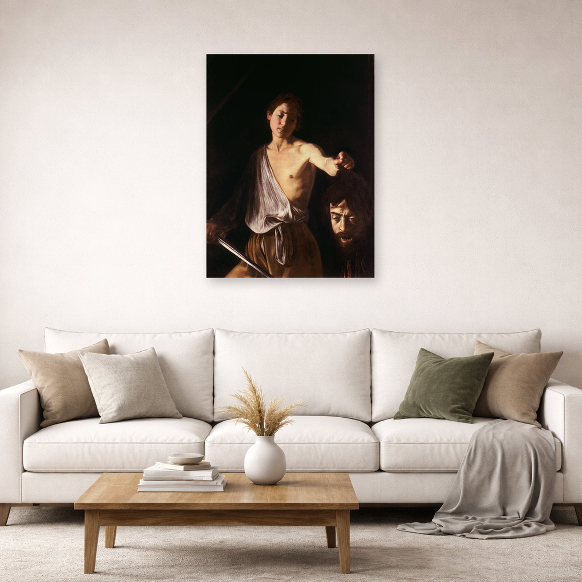 Unframed poster print of Caravaggio's 'David with the Head of Goliath' displayed on a wall in a living room