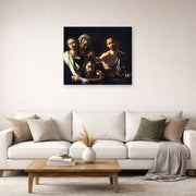 Unframed poster print of Caravaggio's 'Salome with the Head of John the Baptist' displayed on a wall in a living room