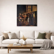 Gallery-wrapped canvas print of Caravaggio's 'The Calling of Saint Matthew' displayed on a wall in a living room