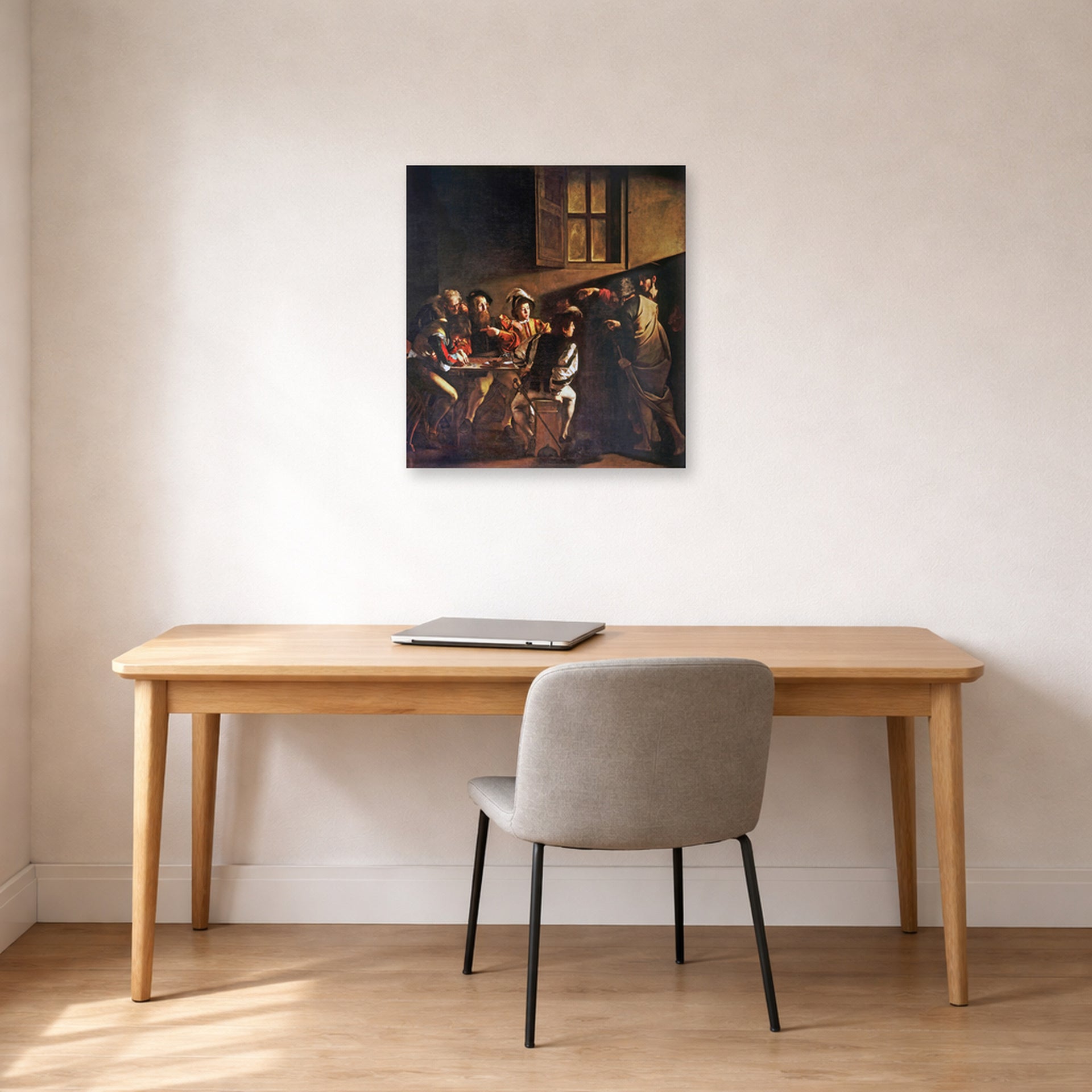 Unframed poster print of Caravaggio's 'The Calling of Saint Matthew' displayed on a wall in an office