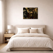 Gallery-wrapped canvas print of Caravaggio's 'The Crowning with Thorns' displayed on a wall in a bedroom