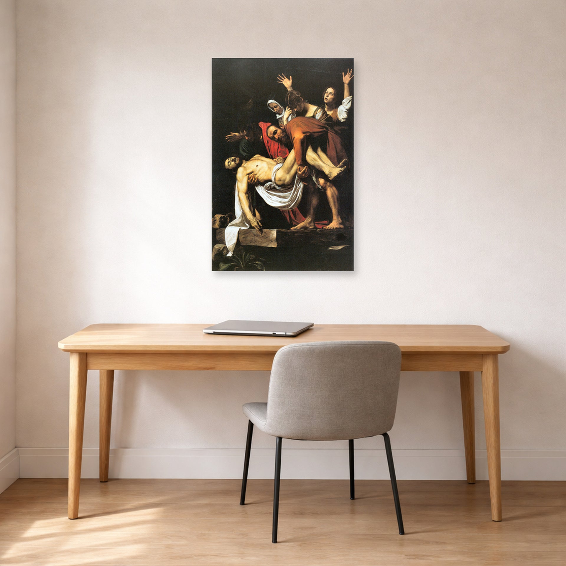 Unframed poster print of Caravaggio's 'The Entombment of Christ' displayed on a wall in an office