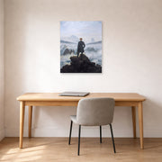 Unframed poster print of Caspar David Friedrich's The Wanderer above the Sea of Fog displayed on a wall in a office