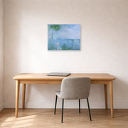 Unframed poster print of Claude Monet's 'Charing Cross Bridge' displayed on a wall in a office