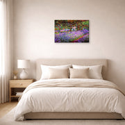 Gallery-wrapped canvas print of Claude Monet's 'The Artists Garden at Giverny' displayed on a wall in a bedroom