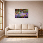 Gallery-wrapped canvas print of Claude Monet's 'The Artists Garden at Giverny' displayed on a wall in a living room