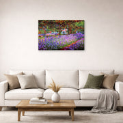 Gallery-wrapped canvas print of Claude Monet's 'The Artists Garden at Giverny' displayed on a wall in a living room