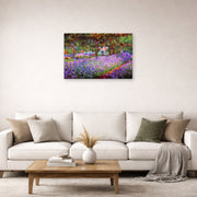 Unframed poster print of Claude Monet's 'The Artists Garden at Giverny' displayed on a wall in a living room