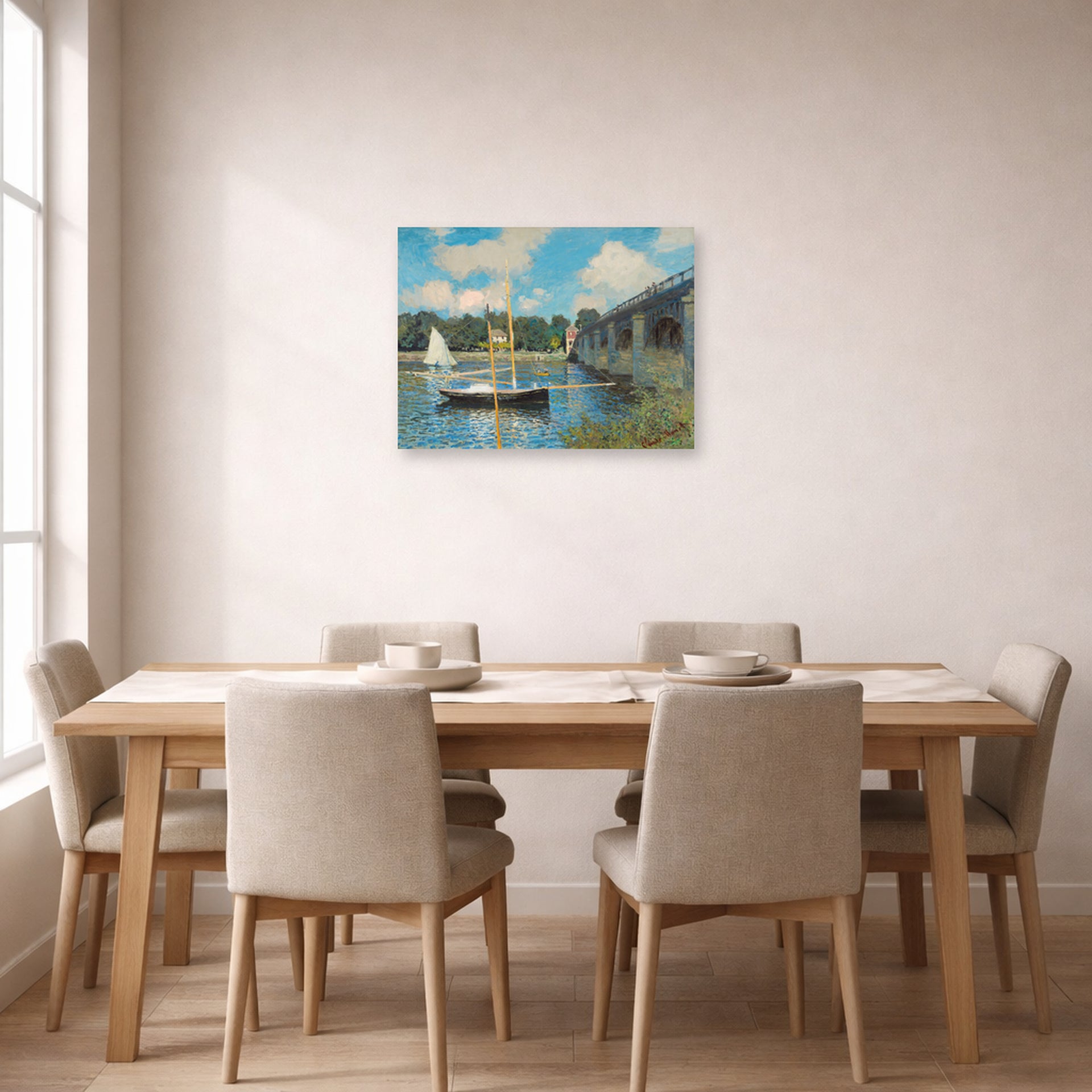 Unframed poster print of Claude Monet's 'The Bridge at Argenteuil' displayed on a wall in a dining room