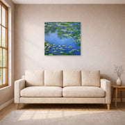 Unframed poster print of Claude Monet's 'Water Lilies' displayed on a wall in a living room
