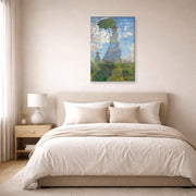Gallery-wrapped canvas print of Claude Monet's 'Woman with a Parasol' displayed on a wall in a bedroom
