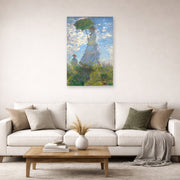 Unframed poster print of Claude Monet's 'Woman with a Parasol' displayed on a wall in a living room