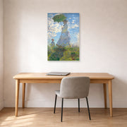 Unframed poster print of Claude Monet's 'Woman with a Parasol' displayed on a wall in a office