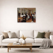 Unframed poster print of Edgar Degas's A Cotton Office in New Orleans displayed on a wall in a living room