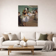 Unframed poster print of Edgar Degas's The Dance Class displayed on a wall in a living room