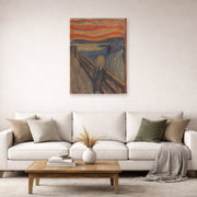Unframed poster print of Edvard Munch's The Scream displayed on a wall in a living room