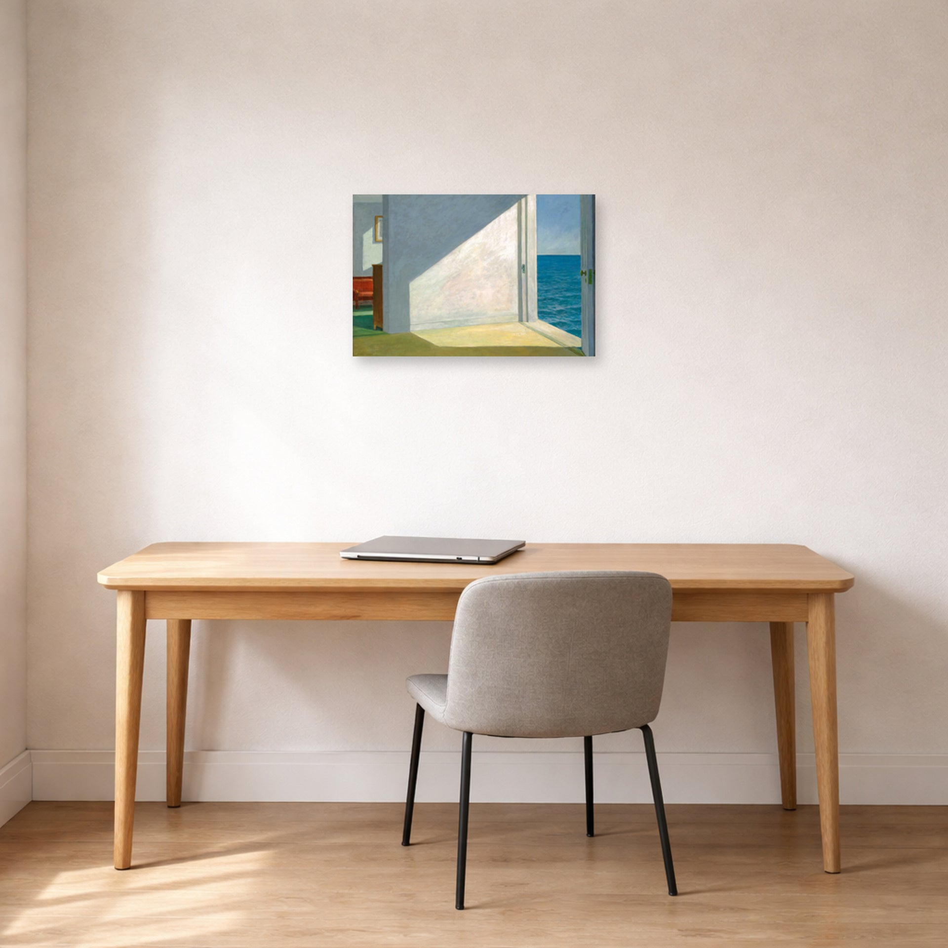 Unframed poster print of Edward Hopper's 'Rooms By The Sea' displayed on a wall in an office