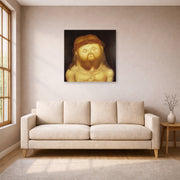 Unframed poster print of Fernando Botero's Head of Christ displayed on a wall in a living room