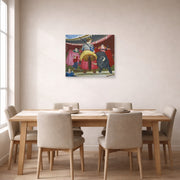 Unframed poster print of Fernando Botero's La Pica displayed on a wall in a dining room