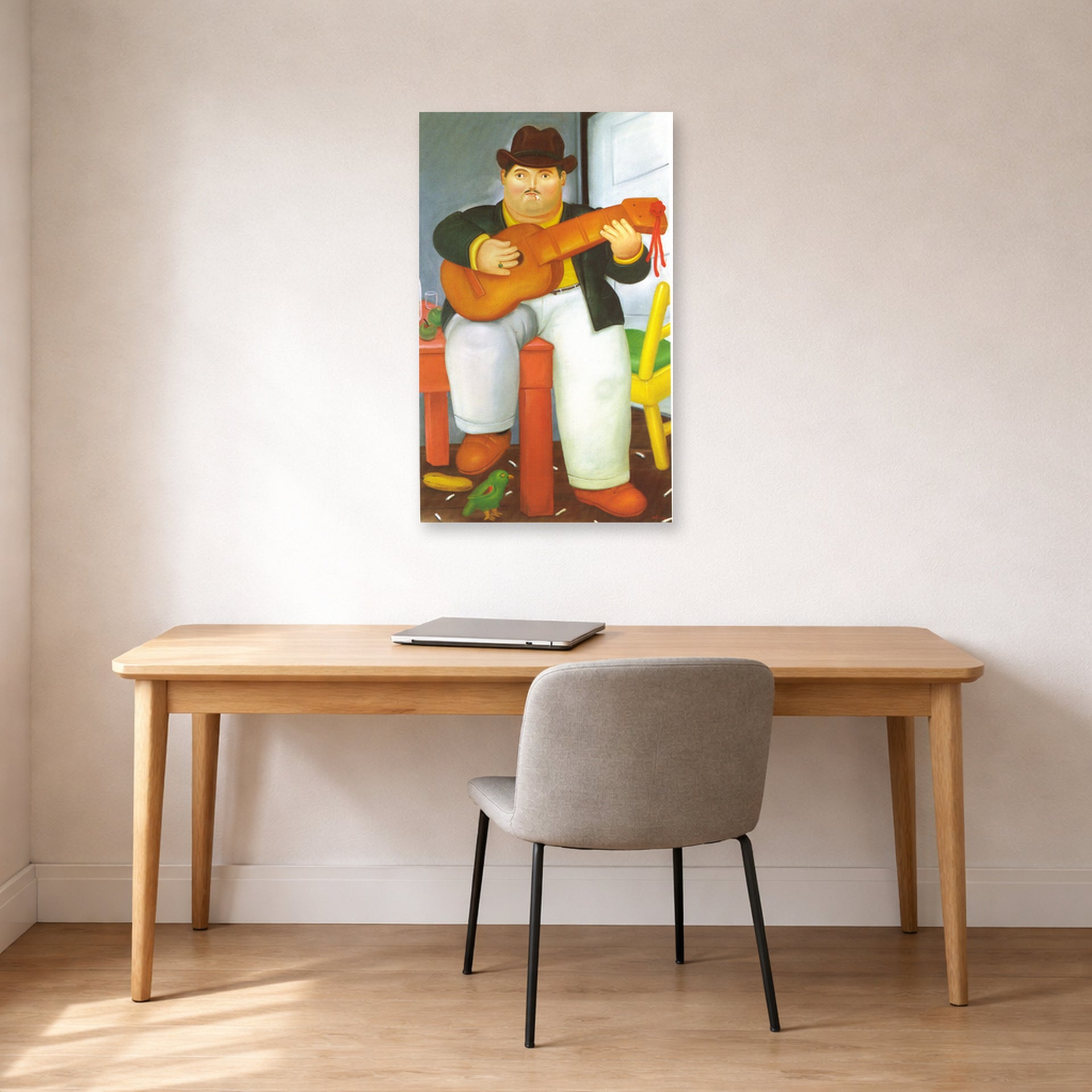 Unframed poster print of Fernando Botero's Man with a Guitar displayed on a wall in a home office