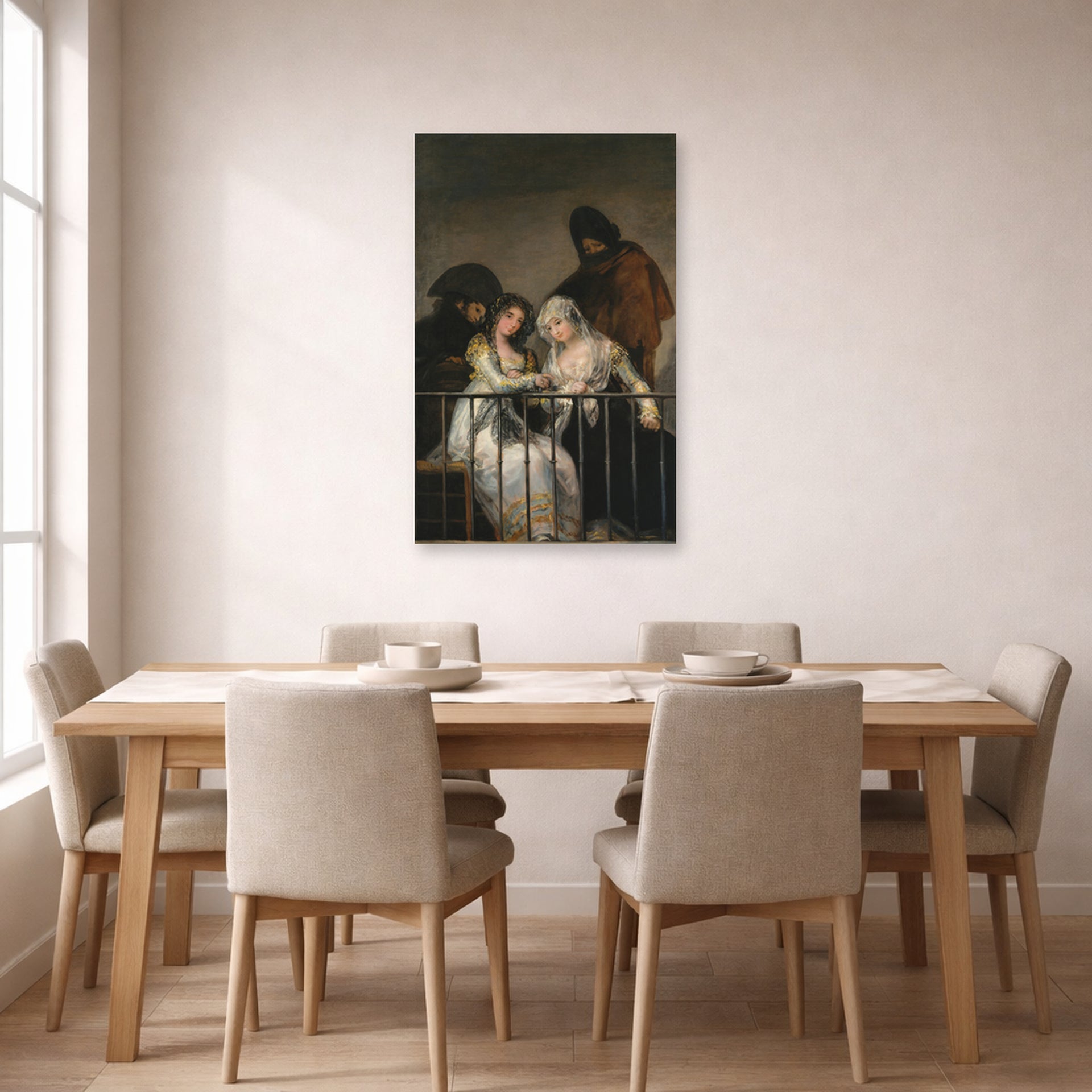 Unframed poster print of Francisco Goya's Majas on a Balcony displayed on a wall in a dining room