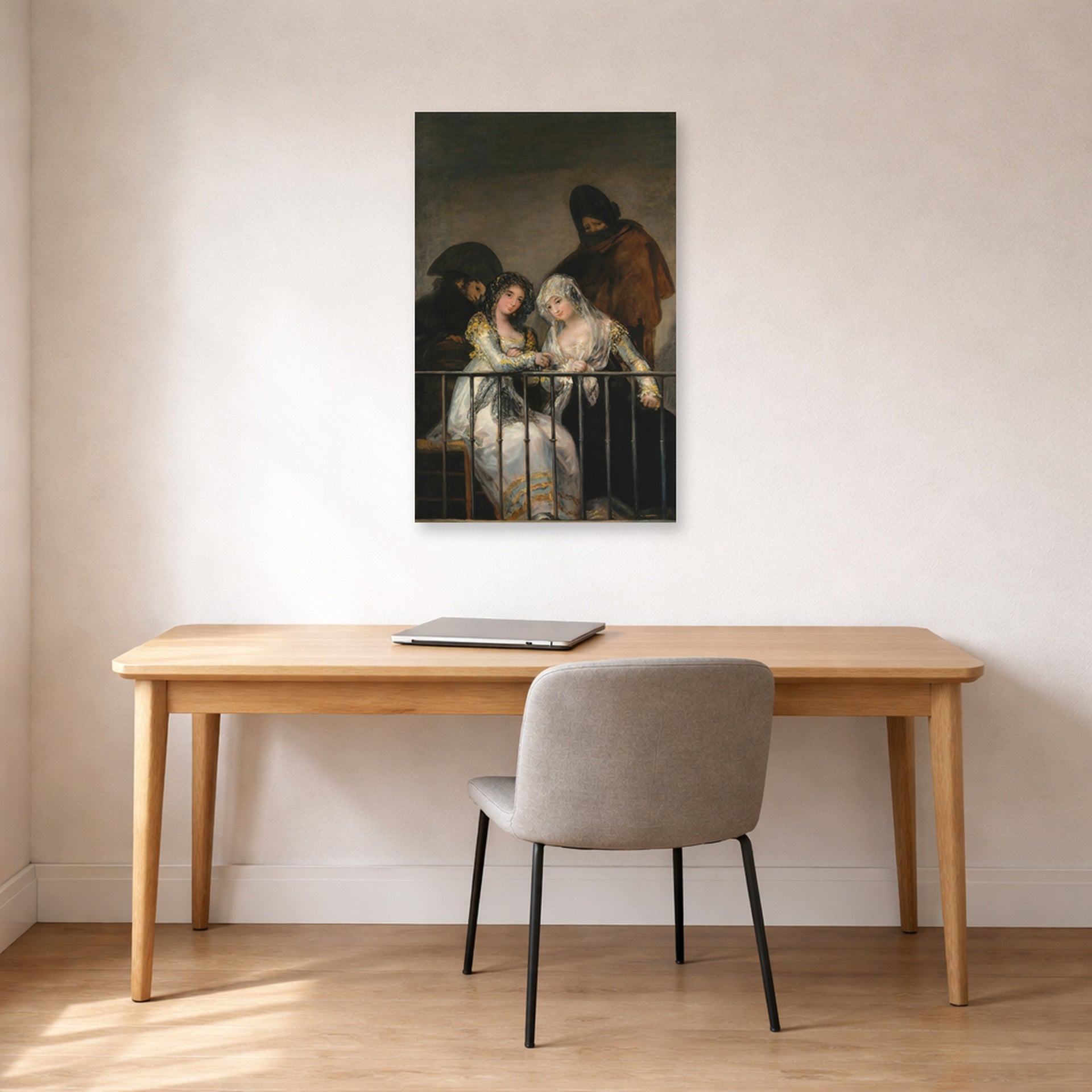 Unframed poster print of Francisco Goya's Majas on a Balcony displayed on a wall in a office