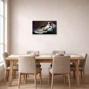Unframed poster print of Francisco Goya's The Nude Maja (La Maja Desnuda) displayed on a wall in a dining room