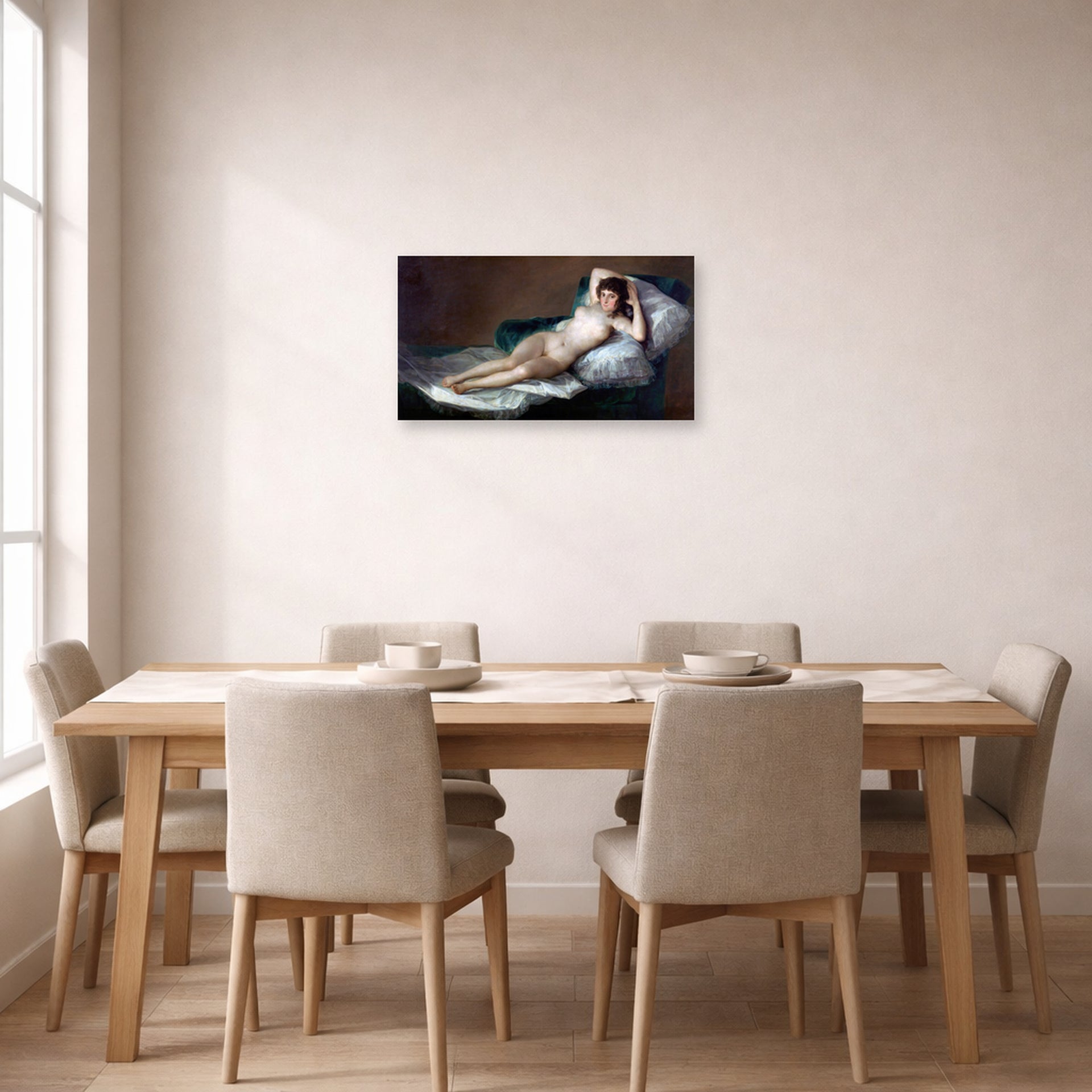 Unframed poster print of Francisco Goya's The Nude Maja (La Maja Desnuda) displayed on a wall in a dining room