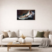 Unframed poster print of Francisco Goya's The Nude Maja (La Maja Desnuda) displayed on a wall in a second living room setting
