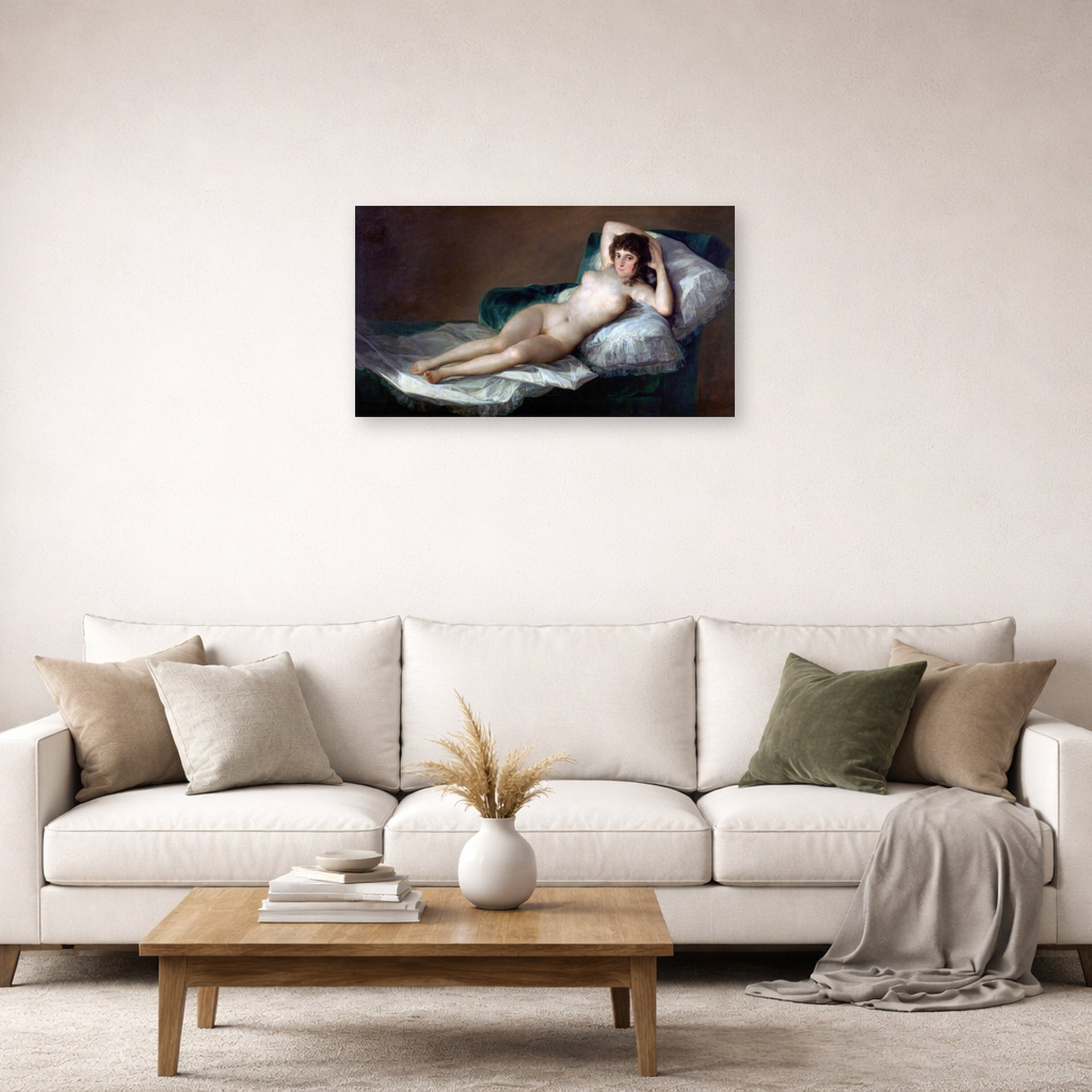 Unframed poster print of Francisco Goya's The Nude Maja (La Maja Desnuda) displayed on a wall in a second living room setting