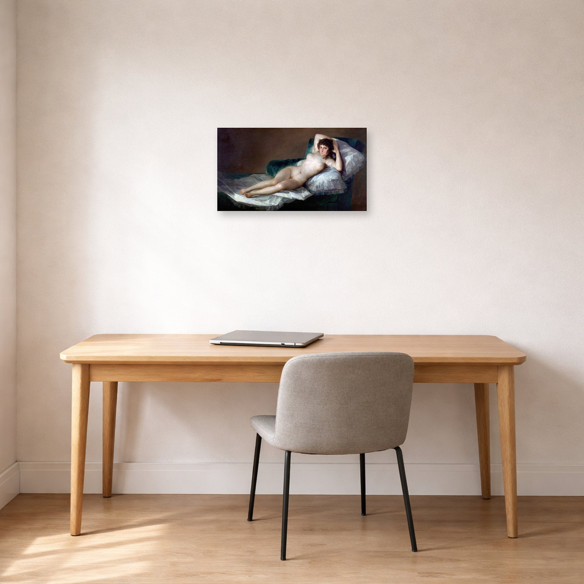 Unframed poster print of Francisco Goya's The Nude Maja (La Maja Desnuda) displayed on a wall in a office
