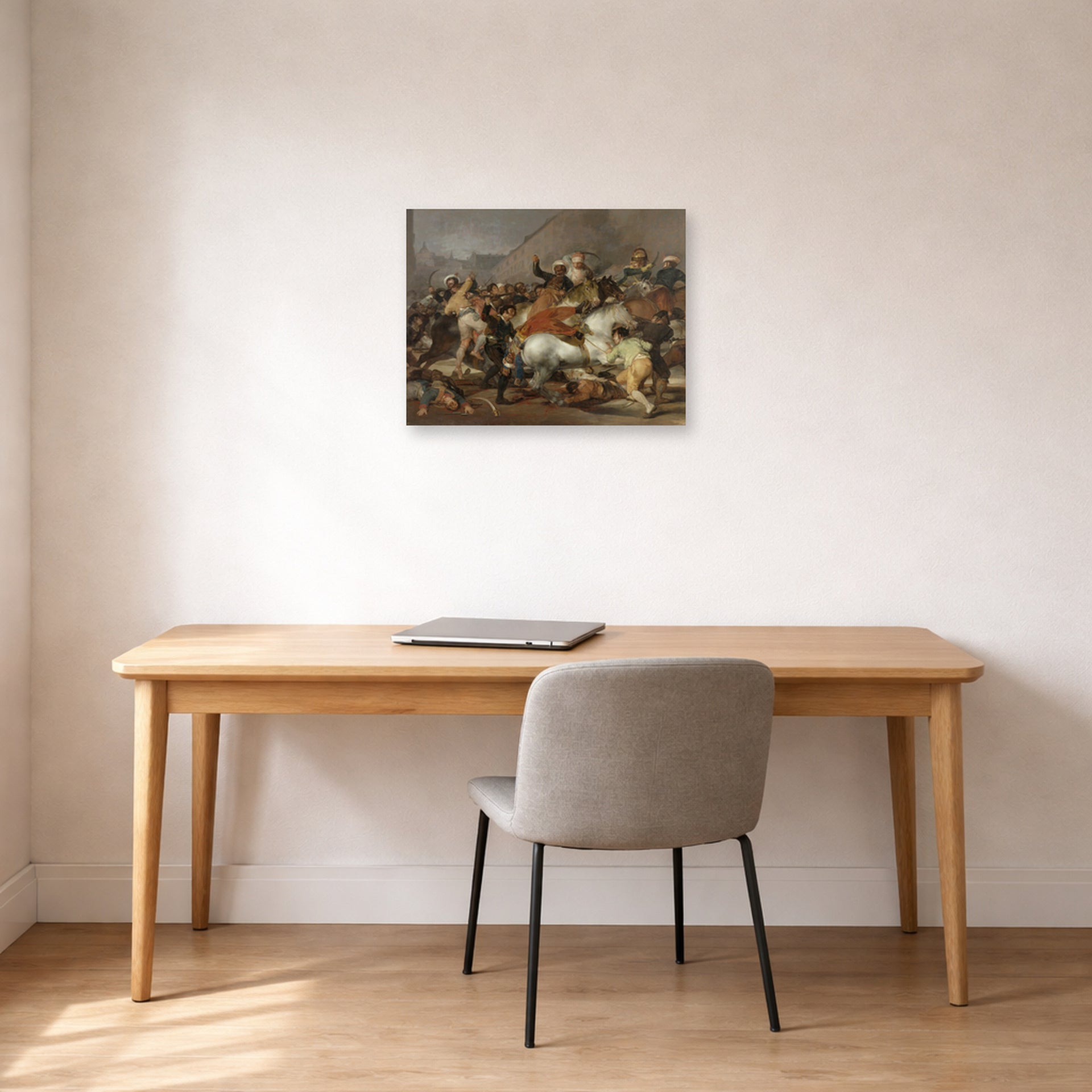 Unframed poster print of Francisco Goya's The Second of May displayed on a wall in a office