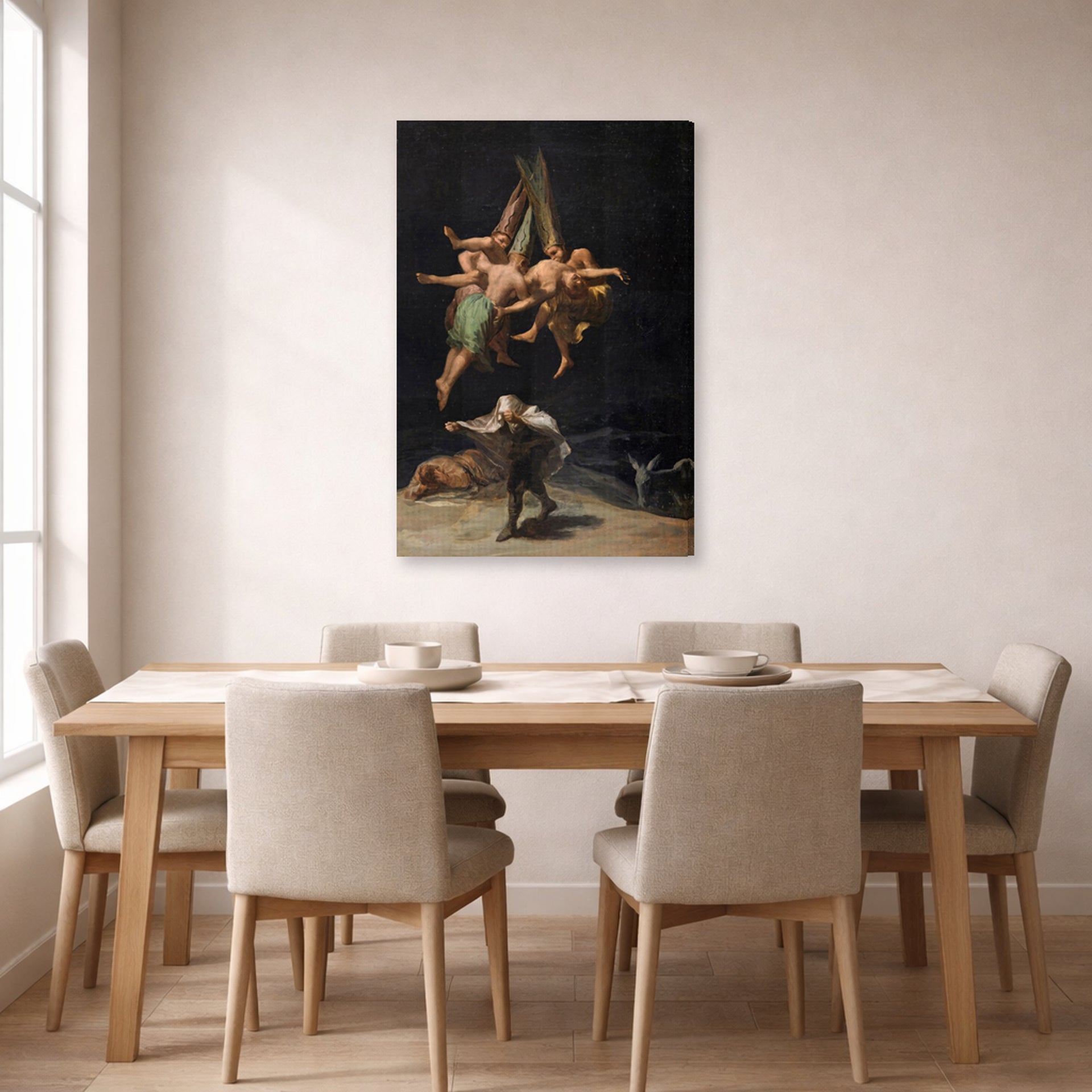 Gallery-wrapped canvas print of Francisco Goya's Witches Flight displayed on a wall in a dining room