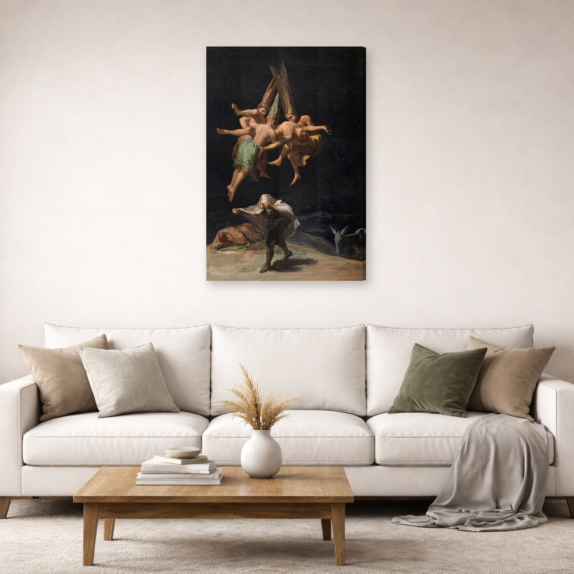 Gallery-wrapped canvas print of Francisco Goya's Witches Flight displayed on a wall in a second living room setting