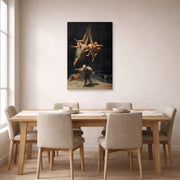 Unframed poster print of Francisco Goya's Witches Flight displayed on a wall in a dining room