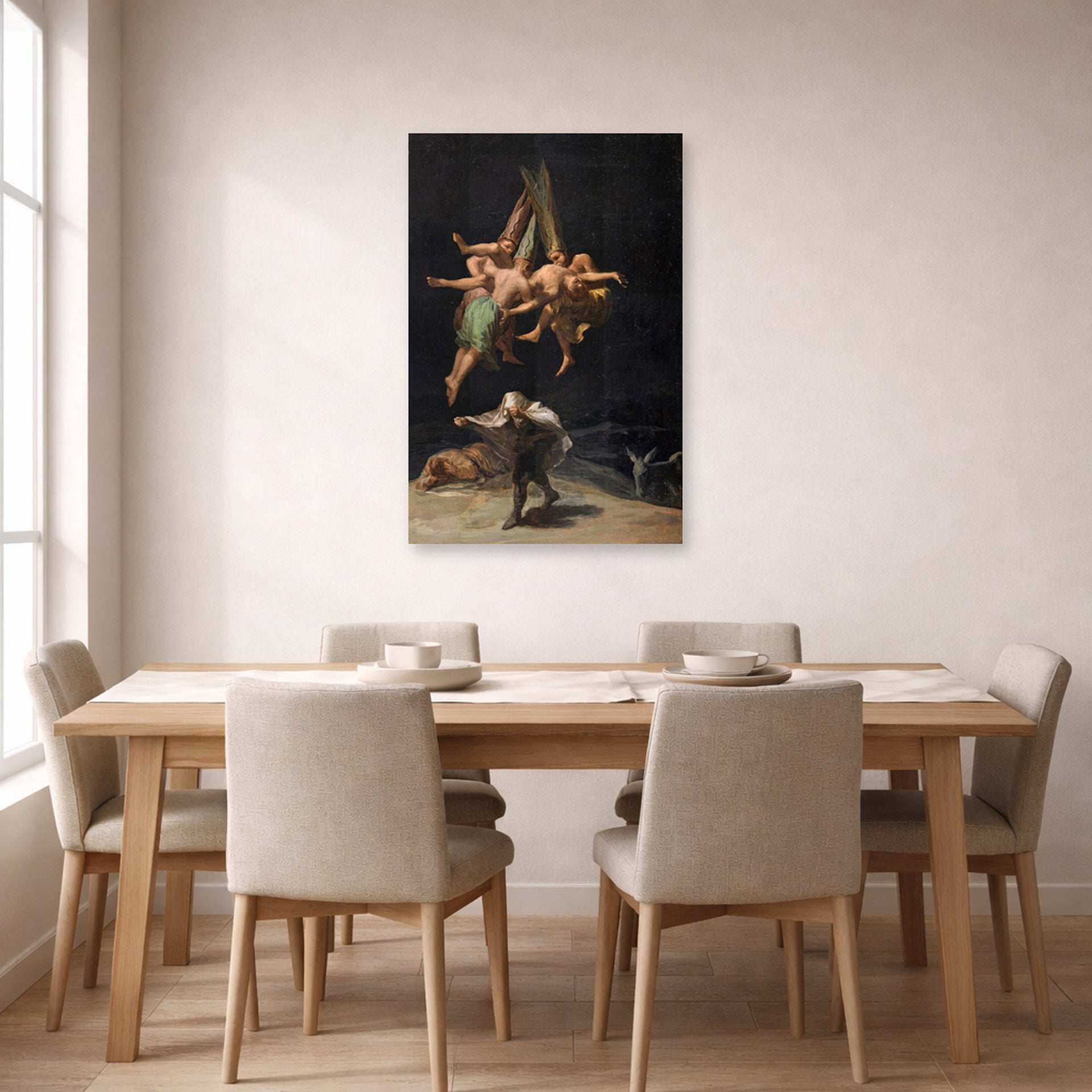 Unframed poster print of Francisco Goya's Witches Flight displayed on a wall in a dining room