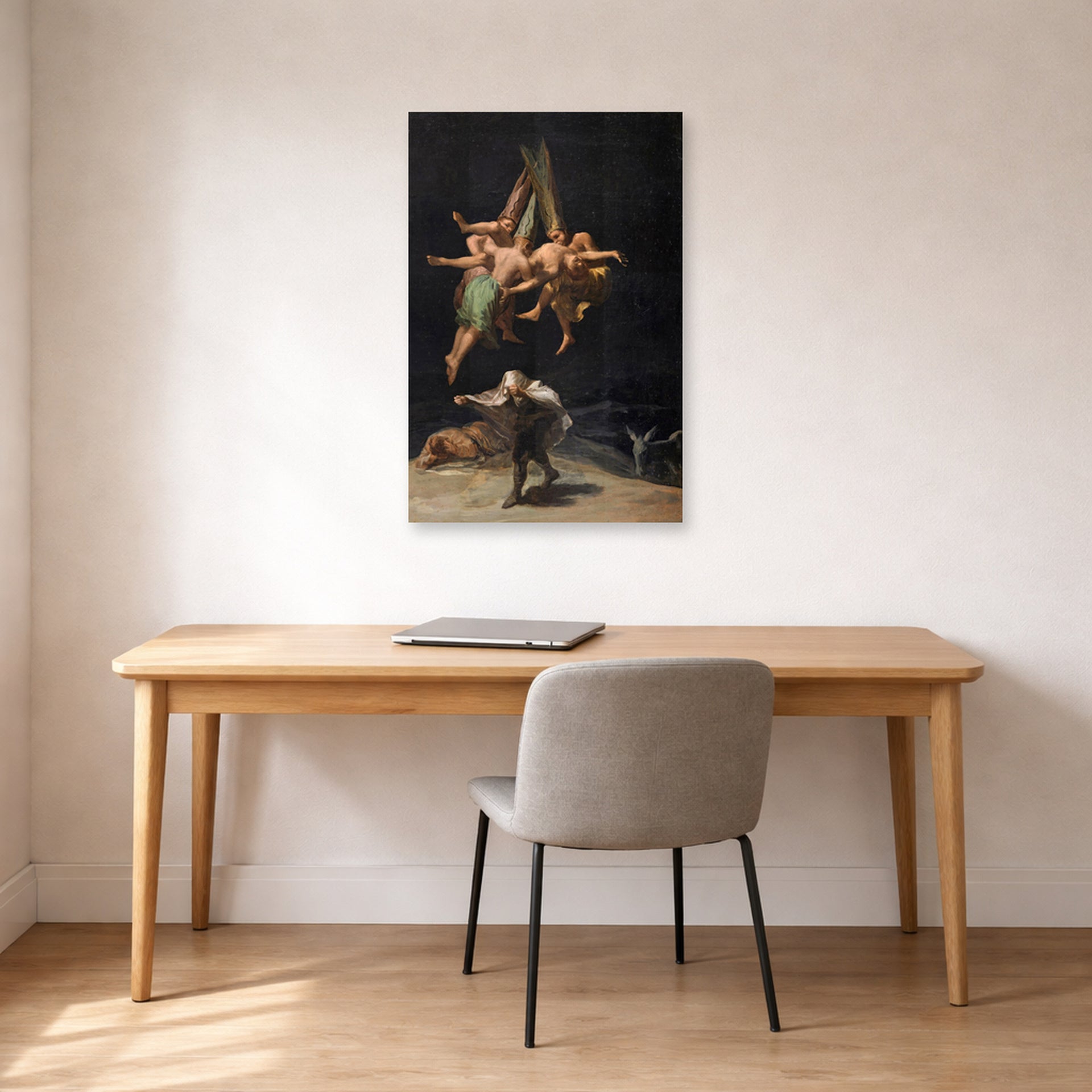 Unframed poster print of Francisco Goya's Witches Flight displayed on a wall in a office