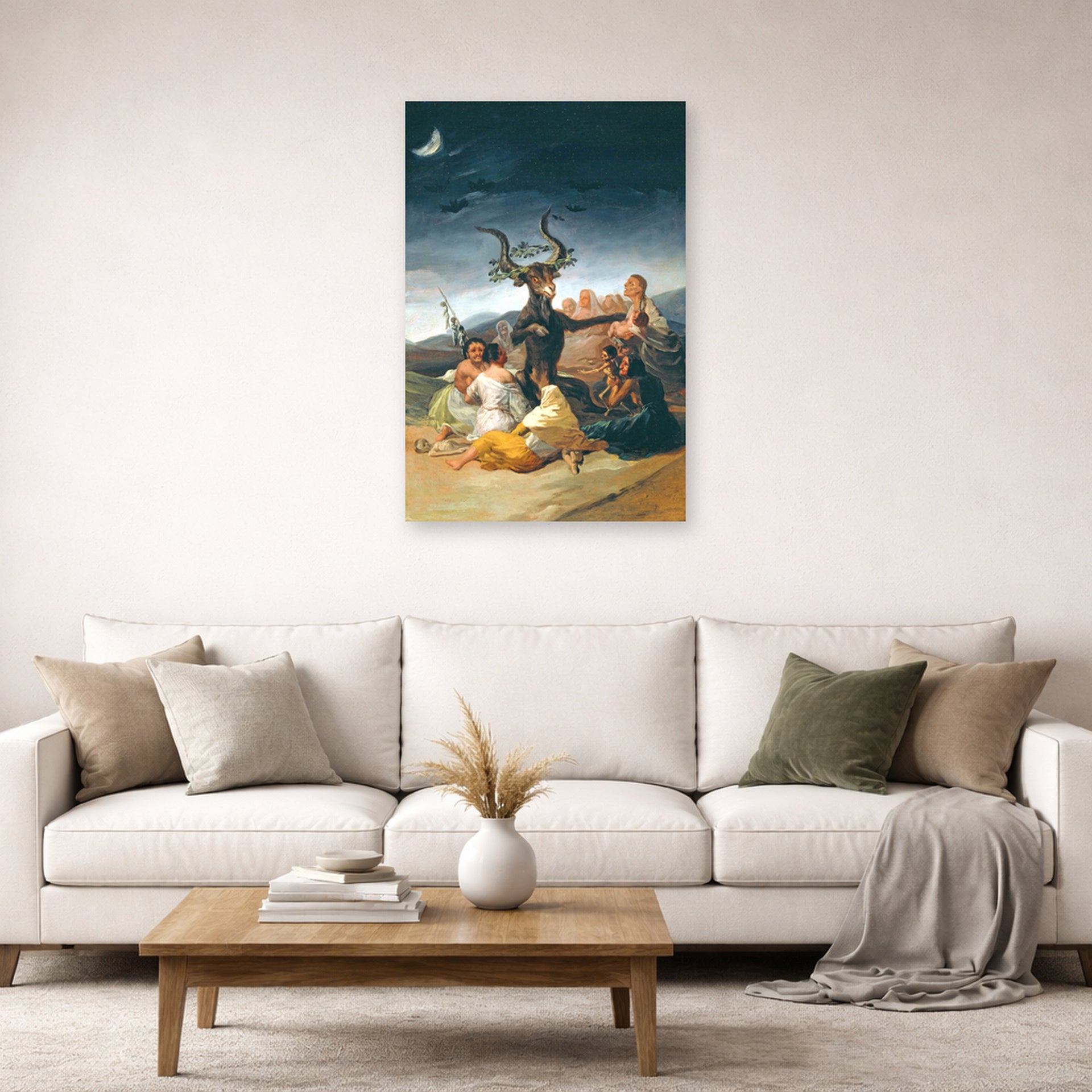 Unframed poster print of Francisco Goya's Witches Sabbath displayed on a wall in a second living room setting